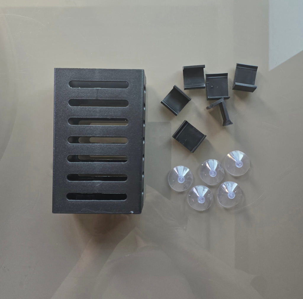 Set of black rectangular components with suction cups on a light gray background