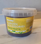 Bucket of coco peat labeled 'Garden Accessories' on a marble surface.